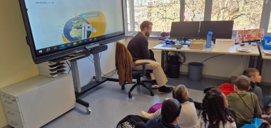 Die Kinder schauen einen Videoclip.